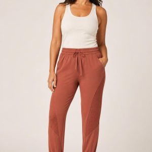 Women's Terracotta Tonal Panel Studio Joggers worn with an adult model