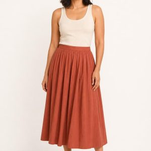 Women's Terracotta Pleated Skirt worn with an adult model