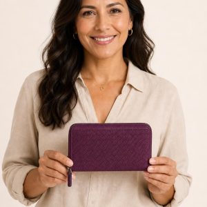Women's Plum Travel Wallet shown with an adult model