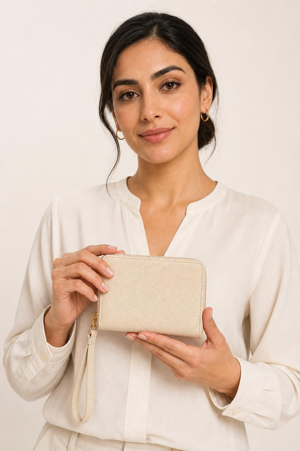 Women's Ivory Wristlet Wallet shown with an adult model